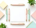 Minimalist Flat Lay of Pastel Stationery with Blank Paper Notebook and Pens on White Desk Background Royalty Free Stock Photo