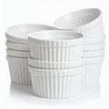 Stacks of pristine ramekins present a minimalist arrangement on white background Royalty Free Stock Photo