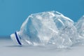 Clean empty crumpled plastic water bottles on blue background Royalty Free Stock Photo