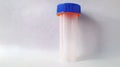 Clean Empty sterile stool sample collection container with blue cap. Medical specimen jar for fecal analysis. Concept of