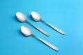 Clean empty table spoons on blue