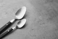 Clean empty table spoons on grey background Royalty Free Stock Photo