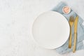 Clean empty white plate, fork and knife on white stone table, copy space, mock up, top view. Concept for menu Royalty Free Stock Photo