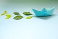 Clean energy for sea and cargo transportation and travel and sustainable maritime transport concept. Paper boat emitting green