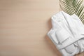 Clean folded bathrobe and slippers on background, flat lay. Space for text Royalty Free Stock Photo