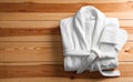 Clean folded bathrobe and slippers on background, top view. Space for text Royalty Free Stock Photo