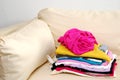 Clean, folded clothes on sofa