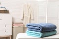 Clean folded towels on table in bathroom Royalty Free Stock Photo