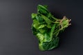 Clean food concept. Bunch of leaves of fresh organic spinach greens on a black background. Healthy detox spring-summer diet. Vegan Royalty Free Stock Photo