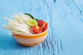 Clean food, vegetables,fresh fruit and spicy herbs in bowl on vibrant wooden