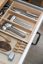 Clean fork spoons and knives in a wooden drawer of the kitchen table neatly folded Royalty Free Stock Photo