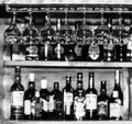 Clean glasses for wine on the background of a bar counter with bottles with various alcoholic beverages