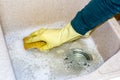 Clean a granite sink with a sponge Royalty Free Stock Photo