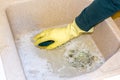 Clean a granite sink with a sponge Royalty Free Stock Photo