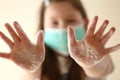 Clean hands concept. Hand washing.Girl in a medical protective mask