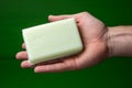 Clean hands White soap in a mans hand on green