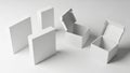 A studio shot of multiple blank white cardboard packaging boxes, including both open and closed mockups, arranged on a seamless Royalty Free Stock Photo