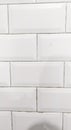 A clean, horizontal arrangement of white square tiles