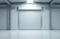 Clean industrial interior with closed metal roller door. Empty space inside large warehouse building. Modern structure with Royalty Free Stock Photo