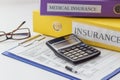 Clean insurance form, folders, pen, glasses and calculator Royalty Free Stock Photo