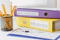 Clean insurance form, folders, pencils in the holder and pen