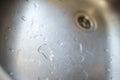 Clean kitchen sink close-up. water drops in a metal washbasin