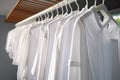 Clean laundry hanging on drying rack indoors close Royalty Free Stock Photo