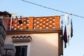 Clean linen is dried on a brick balcony in Croatia