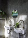 Clean loft style bathroom interior with white modern sink basin and brass faucet. Royalty Free Stock Photo