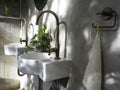 Clean loft style bathroom interior with white modern sink basin and brass faucet. Royalty Free Stock Photo