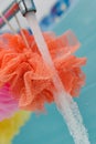 Clean loofahs hanging from a bathroom spigot Royalty Free Stock Photo