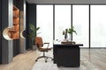 Clean luxury office interior with window and city view, bookcase and other objects.