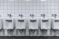 Clean male toilet row of urinals in a public restroom Royalty Free Stock Photo