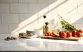 Clean minimal white marble kitchen countertop with cooking ingredients tomato asparagus bowl in morning sunlight on white square Royalty Free Stock Photo
