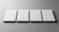 Four blank white rectangular blocks arranged side by side on a smooth gray surface Royalty Free Stock Photo