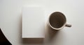 Minimalist Workspace Coffee Mug and Blank Paper Stack on White Surface Royalty Free Stock Photo