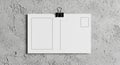 Blank Postcard Mockup on Textured Wall with Binder Clip Royalty Free Stock Photo