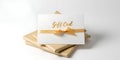 Modern White Gift Card with Elegant Gold Ribbon Bow and Minimalist Design for Festive Occasions Royalty Free Stock Photo