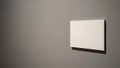 Minimalist Blank White Canvas on Gray Wall with Copy Space Royalty Free Stock Photo
