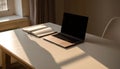 Modern Workspace: Laptop and Open Notebook Bathed in Sunlight Royalty Free Stock Photo