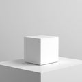 Minimalist white cube centered on a white platform against a soft gray background Royalty Free Stock Photo