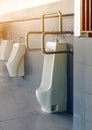 Clean and modern public men toilet with friendly design for people with disability or elderly with stainless steel handles and all Royalty Free Stock Photo