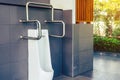 Clean and modern public men toilet with friendly design for people with disability or elderly with stainless steel handles and all Royalty Free Stock Photo