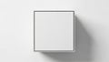 A clean and modern top-down view mockup featuring a blank white square box casting a soft shadow on a plain white surface for Royalty Free Stock Photo