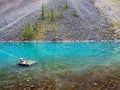 Clean mountain lake. Azure glacial lake with clear water surface in sunlight. Beautiful scenic landscape with turquoise mountain Royalty Free Stock Photo