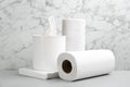 Clean napkins, box with tissues and rolls of paper towels on light table Royalty Free Stock Photo