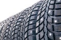 Clean new modern studded winter tires in row. Tires with spikes, close up, Royalty Free Stock Photo