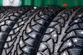 Clean new modern studded winter tires in row. Tires with spikes, close up Royalty Free Stock Photo