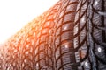 Clean new modern studded winter tires in row. Tires with spikes, close up Royalty Free Stock Photo