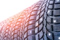 Clean new modern studded winter tires in row. Tires with spikes, close up Royalty Free Stock Photo